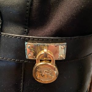 Black Michael Kors riding boots